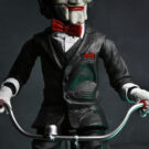 NECAOnline.com | Saw - 12" Action Figure with Sound - Puppet on Tricycle